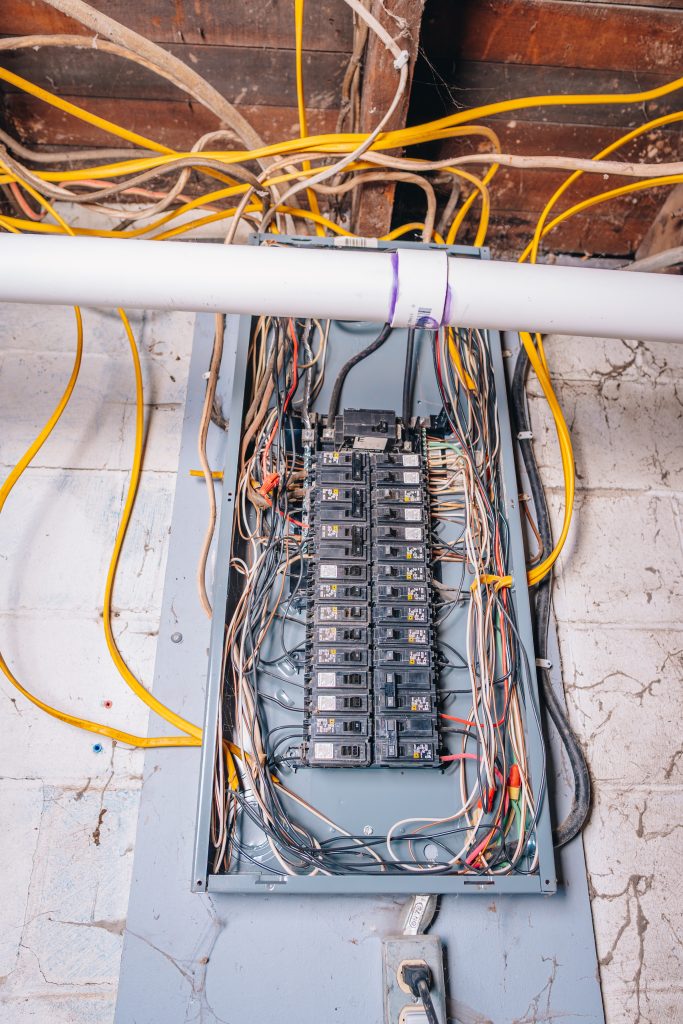 Close-up of electrical panel in basement at 11 Sherman Street, Dennison, Ohio with updated wiring.