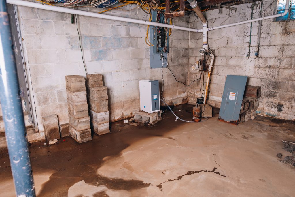Basement at 11 Sherman Street, Dennison, Ohio with electrical panel, concrete blocks, and exposed wiring
