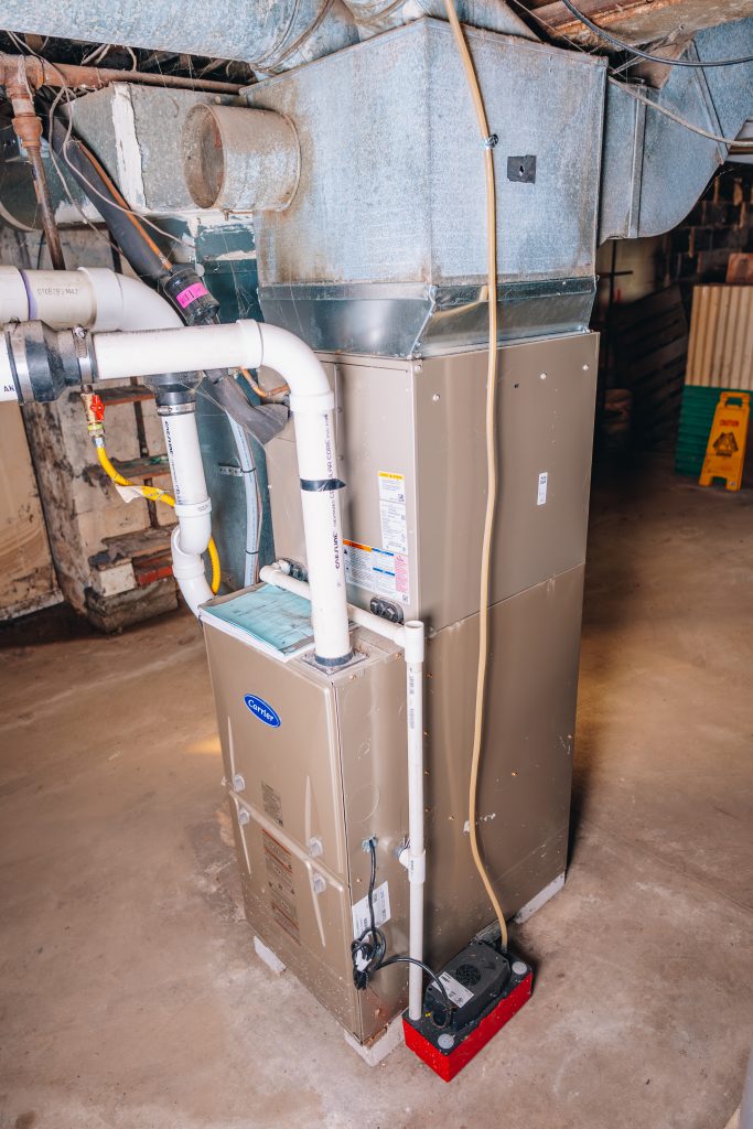 New furnace and air conditioning system installed in 2023 at 11 Sherman Street, Dennison, Ohio located in basement utility area.