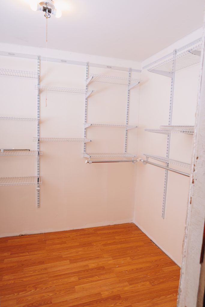 First-floor bedroom walk-in closet at 11 Sherman Street, Dennison, Ohio remodeled in 2019 with wall-mounted shelving.