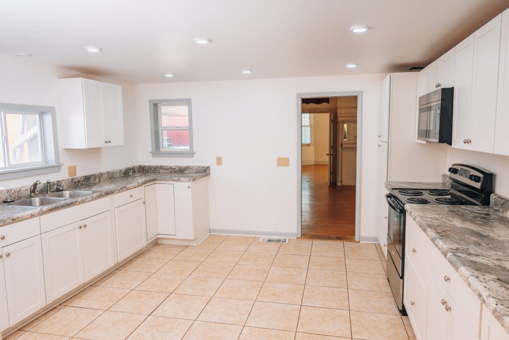 Open-layout kitchen at 11 Sherman Street, Dennison, Ohio with tile flooring and entry to living area.