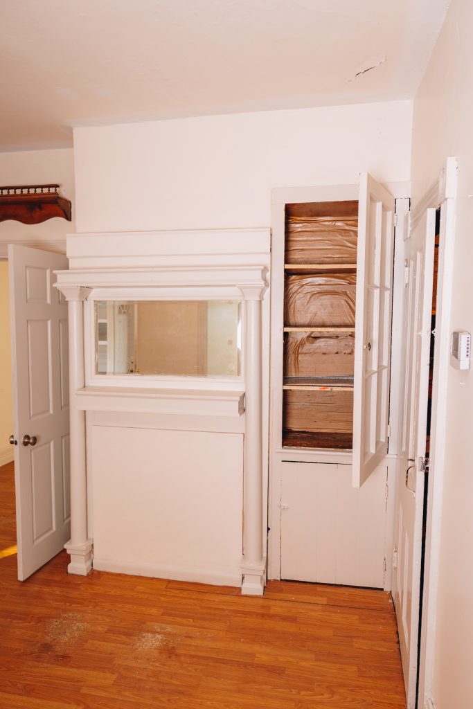 Living room at 11 Sherman Street, Dennison, Ohio featuring built-in millwork with display niche and cabinet storage.
